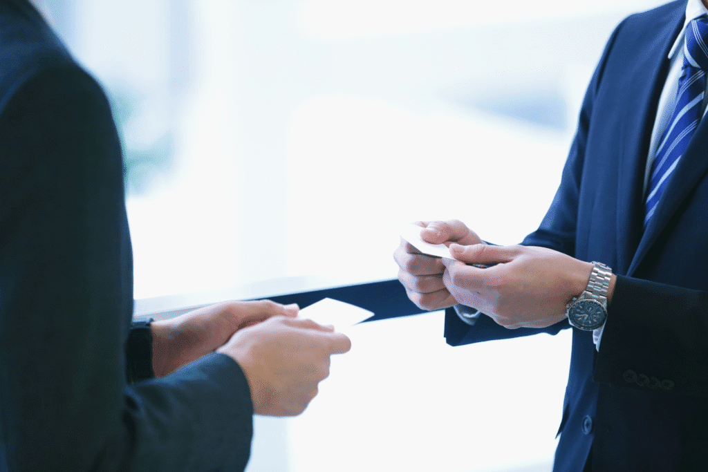 Two people networking and exchanging business cards